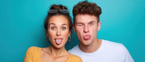 Playful young couple making silly faces against bright background fun portrait indoor close-up joyful concept photo