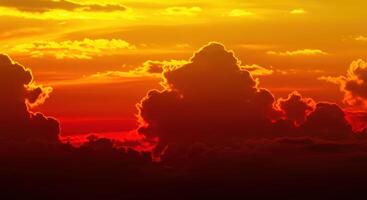 Dramatic fiery skyline at sunset with voluminous clouds on horizon photo