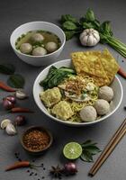 Aromatic noodle soup composition with diverse toppings on an atmospheric background photo
