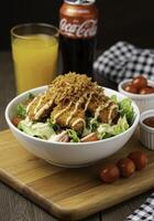 Culinary Presentation Fresh Salad Bowl with Crispy Toppings and Beverage Accompaniments photo