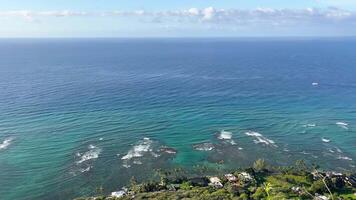 Aerial view of calm ocean horizon and coastal homes, scenic blue waters of Hawaii video