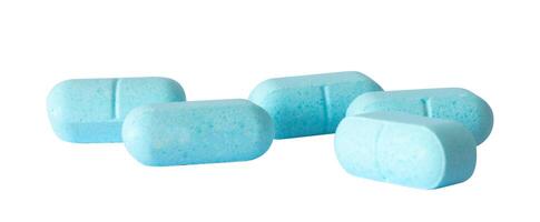 blue drug tablets on white surface photo