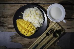 Street food with sticky rice and ripe mangoes is very delicious and popular among Thai people. photo