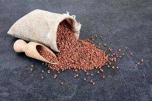 Raw buckwheat on black as a background photo