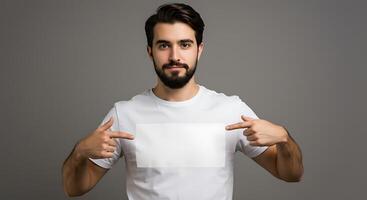 Man with a white t - shirt pointing at blank screen photo