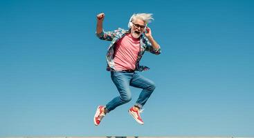 A man jumping in the air with his hands in the air photo