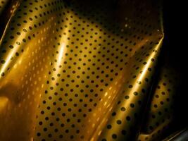 Gold plate texture with dots and reflection at night for luxury vintage background. photo