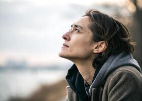A woman with a thoughtful, deep gaze. Her expressive facial features convey inner reflections, a creative mood photo
