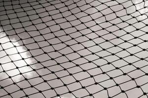 Abstract monochrome goal net with cloud background. Panorama landscape of knot rope in balck and white. Shadow and silhouette. Sports and entertainment. Textured Wallpaper. Negative space photo