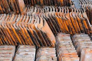 Pile of mossy roof tiles. A collection of backgrounds of dismantled roof tiles replaced with new roof tiles. Abstract textured wallpaper backgrounds. Texture and details. Text space photo
