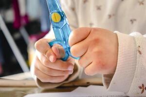 Child having fun with an authentic leisure activity, fine motor skills development, table photo