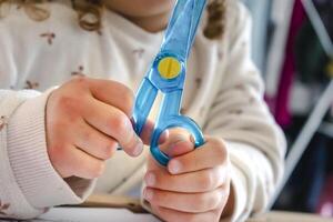 Child having fun with an authentic leisure activity, fine motor skills development, active photo