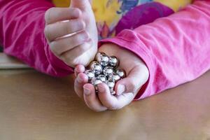 Child having fun with an authentic leisure activity, fine motor skills development, learn photo