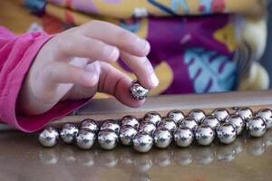 Child having fun with an authentic leisure activity, fine motor skills development, education photo