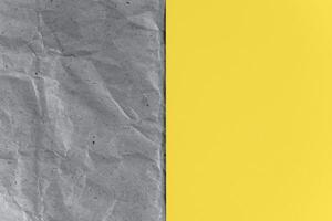 Gray craft paper and yellow sheet. Texture background, top view. Trending colors 2021. photo