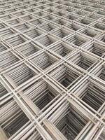 Optical illusion photo of stack of wire mesh iron. A group of cast iron forms a rectangle with three-dimensional depth. Construction Industry. Hardware and building materials store. Space
