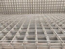 Optical illusion photo of stack of wire mesh iron. A group of cast iron forms a rectangle with three-dimensional depth. Construction Industry. Hardware and building materials store. Copy Space
