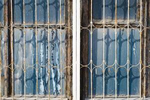 Two windows with bars on them photo