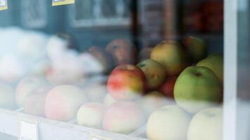 Red, green apples on a shop window. Selective focus photo