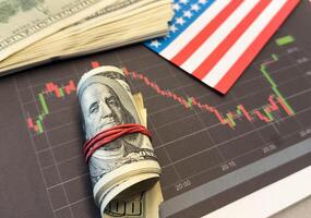 Crisis in USA, rising inflation, devaluation of dollars and the economy. Stock market trading graph with american flag is damage.Effect of recession US economy photo