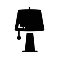 A well designed glyph style icon depicting table lam vector