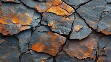 Textured rock surface showcasing vibrant orange and dark gray hues in natural setting photo