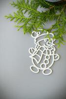 Christmas card. Christmas composition with a white ball and a snowman in the snow photo