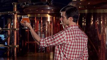 Joyful brewer giving thumbs up while proudly holding a glass of beer video