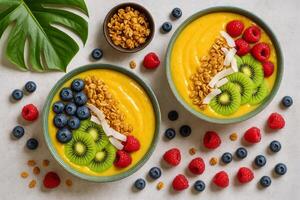 Fresh Tropical Smoothie Bowls Topped With Fruit and Granola, Perfect for Breakfast or a Healthy Snack photo