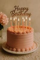 Delightful Birthday Cake With Candles and a Decorative Sign at a Celebration photo
