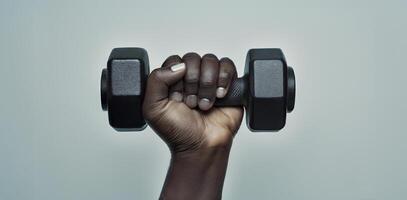 A person holding a dumbbell in their hand photo