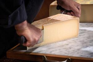 Famous and tasted part of cheese ha sbeen cuted with a wire photo