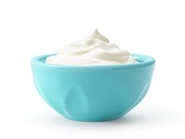 Creamy white substance in a turquoise bowl on a plain background photo
