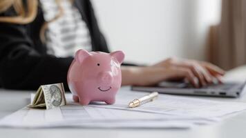 Saving strategies with a piggy bank and financial paperwork during a budget planning session photo