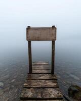 Wooden dock disappearing into the fog photo