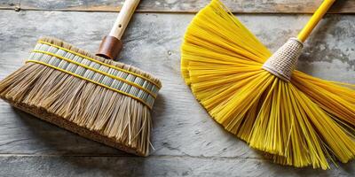 Rustic brooms resting on a textured stone surface. photo