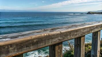 Ocean view from a wooden deck with waves crashing below. photo