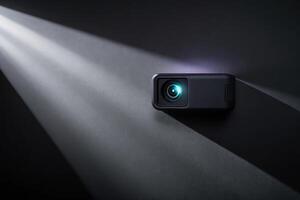 A small projector casting a beam of light in a dark room. photo