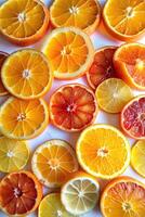 Sliced citrus fruits arranged in a vibrant, colorful pattern. photo