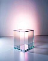 Light refracting through a glass cube on a sleek surface. photo