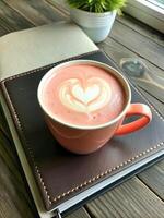 Heart-shaped latte art in a cozy coffee shop setting. photo