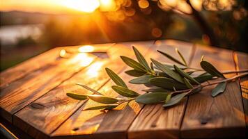 Olive branches casting shadows on a sunlit wooden table. photo