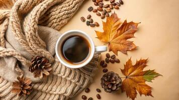 Cozy autumn setup with coffee, leaves, and a warm scarf. photo