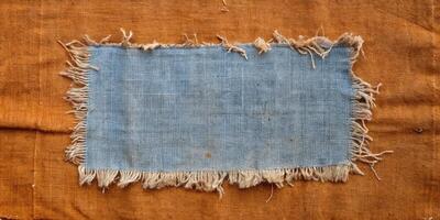 Rustic blue fabric with frayed edges on a wooden table. photo