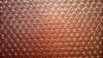 Copper bubble wrap texture with reflective shine. photo