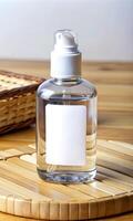 Transparent pump bottle with blank label on bamboo surface photo