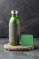 Green glass bottle and bar of soap on a stone with minimalist background photo