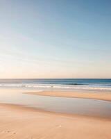 Serene beach with gentle waves under a clear sky. photo