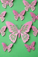 Pink butterflies arranged on a green background in a delicate pattern. photo
