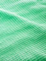Green mesh fabric with a subtle checkered pattern. photo